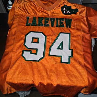 Orange team football jersey with 'Lakeview' and number 94 in green-and-white embroidery.